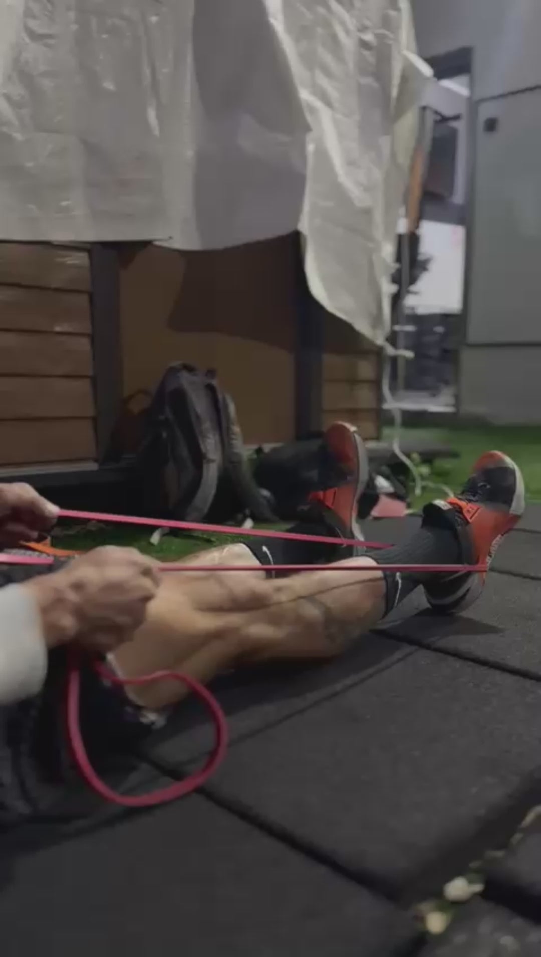 Load video: Sit with legs straight, loop the band around the ball of your foot, and hold the ends. Press your foot down and forward, like pressing a gas pedal.